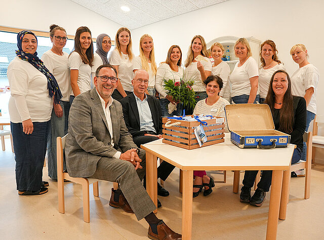 Auf dem Bild ist eine Gruppe von Menschen zu sehen, die sich über die Einweihung der neuen Kita in der Johann-Heinz-Straße in Pforzheim freuen. Baubürgermeister Tobias Volle, Sozialbürgermeister Frank Fillbrunn, Claudia Lorena Rautenberg, Leiterin Amt für städtische Kindertageseinrichtungen sowie Stadtbau-Prokuristin Karin Günther und Kita-Leiterin Katja Diesner.