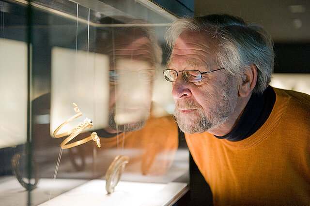 Fritz Falk looks into the display case where the snake bangle he purchased is on show.