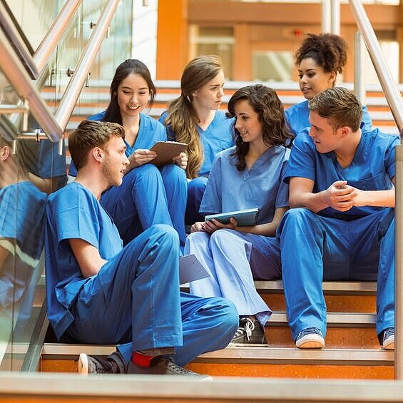 Medical students taking a break on the steps at the university